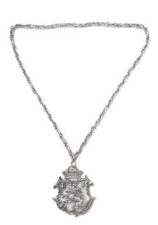 Large silvertone metal heraldic crest pendant necklace. The pendant 