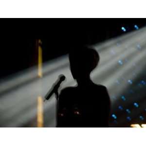 Female Singer and Microphone Silhouetted with Stage Lights Stretched 